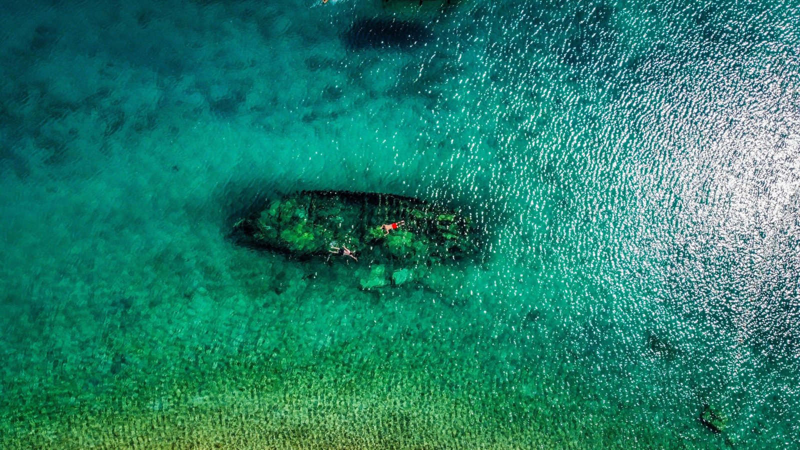 Snorkel in the crystal-clear waters of the Sapona shipwreck