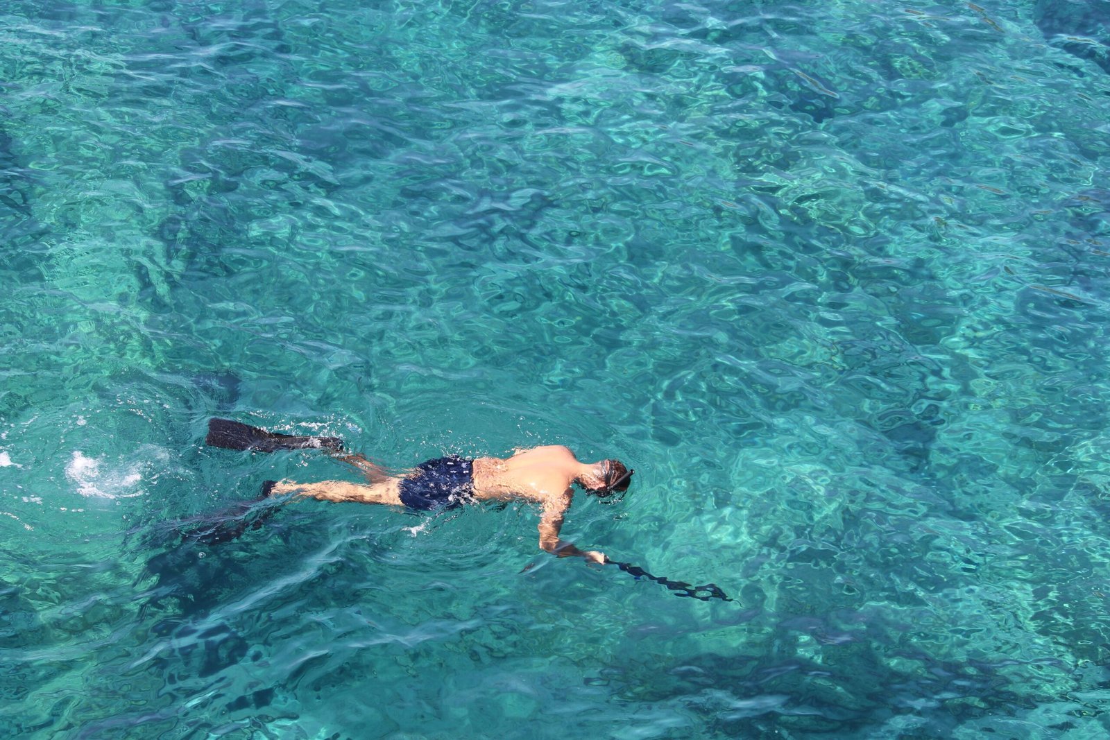 Snorkel or dive in the crystal-clear waters of Coki Beach.