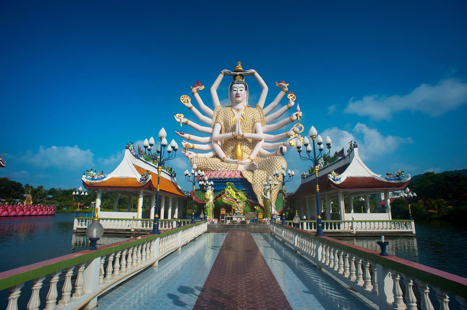 Explore the serene Wat Plai Laem, known for its intricate statues and colorful architecture.