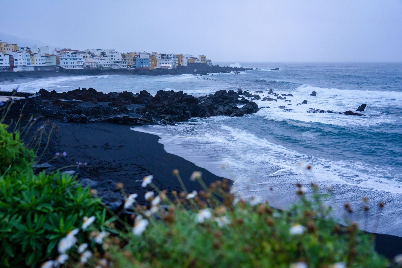 Relax on the black sand beaches of La Plage de Papenoo.