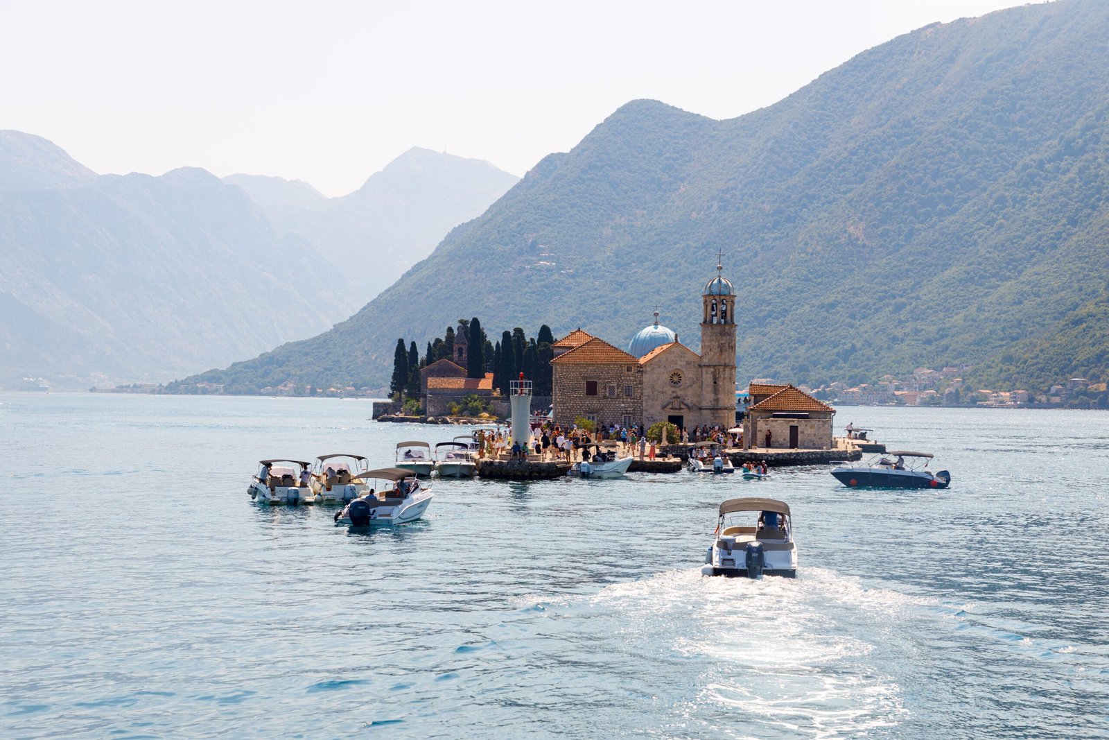 Take a boat trip to the picturesque island of Our Lady of the Rocks in the Bay of Kotor.
