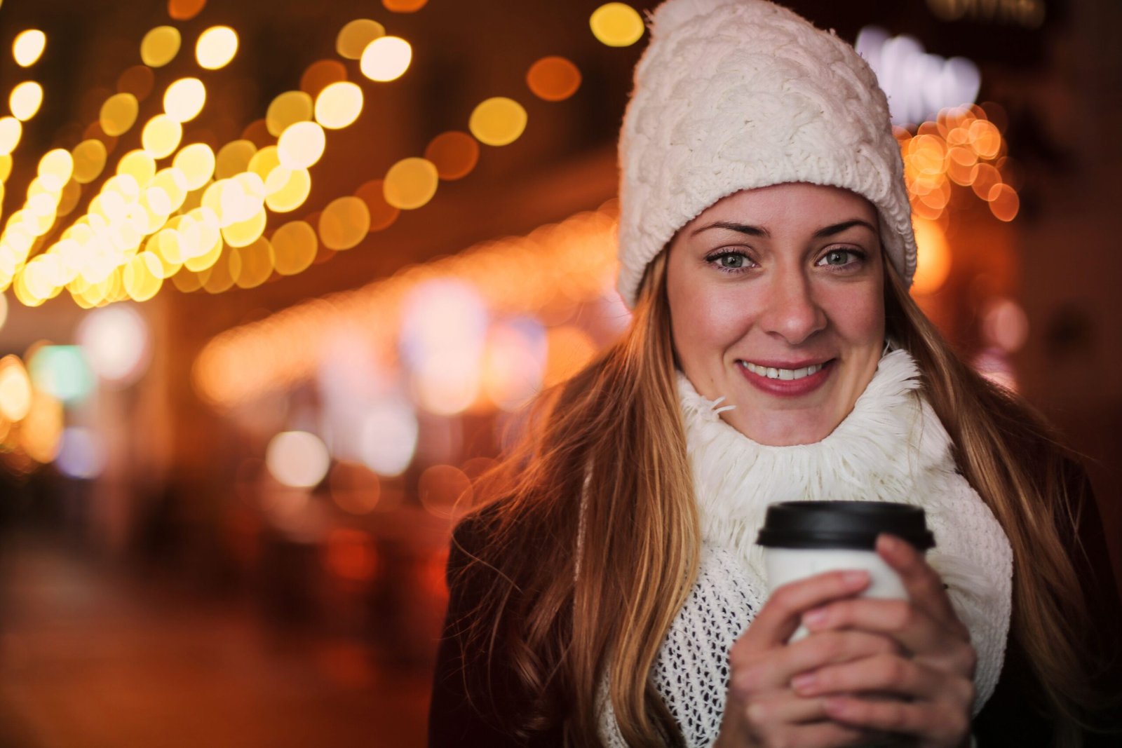 Enjoy a warm drink at a cozy café during a winter festival