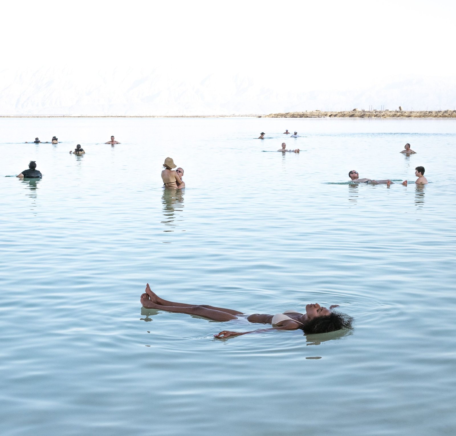 Float in the Dead Sea, known for its high salt content and therapeutic properties.